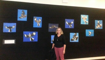 Kristi Pfister with student paintings