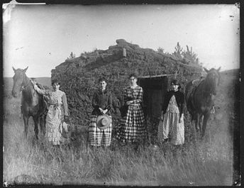 4 women and sod house on prairie