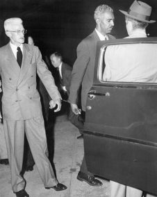 (Original Caption) New York: Held In Contempt Of Court. Mystery writer Dashiel Hammett (Left), chairman of the Civil Rights Congress' Bail Fund, and W. Alphaeus Hunton, a trustee, are handcuffed together as they enter a police van after being remanded to cells for contempt of court, July 9. Both men refused to answer Federal Judge Sylvester Ryan's questions about who put up the money for the four Communist leaders who have jumped their bail. Another trustee, millionaire Frederick Vanderbilt Field, has been sentenced to 90 days on the same charge.